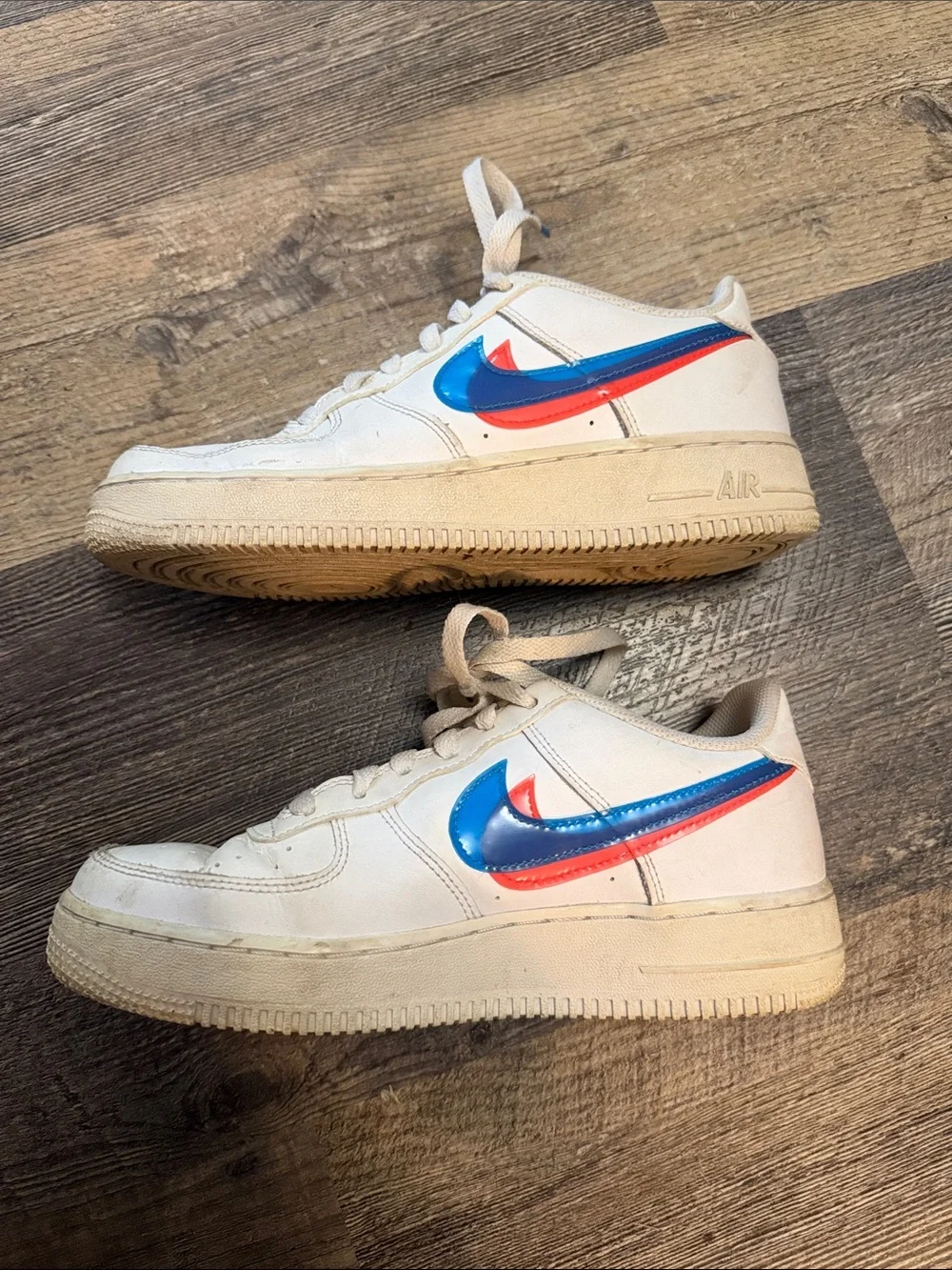 Nike White Low-Top Sneakers with Blue and Red Swoosh